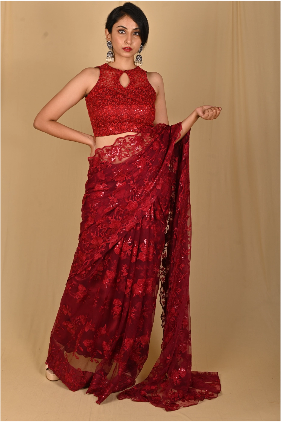 maroon-net-saree-with-all-over-sequin-embroidery-paired-with-matching-sleeveless-halter-neck-blouse-custom-tailored?uid=1674831134