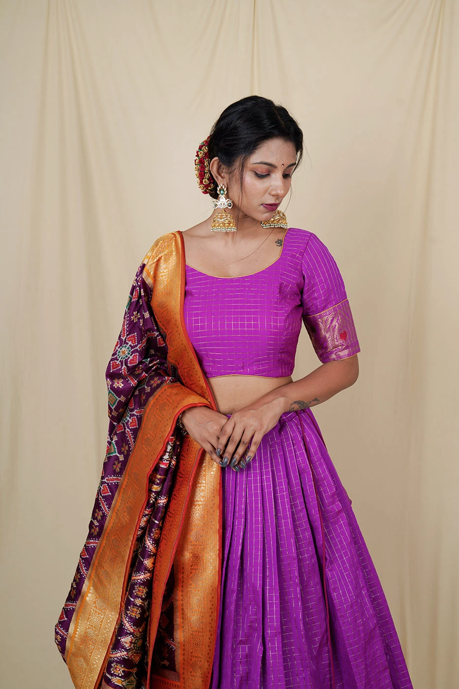 purple-silk-lehenga-with-all-over-checks-and-big-border-paired-with-matching-blouse-and-pure-patola-dupatta-m?uid=1676379886