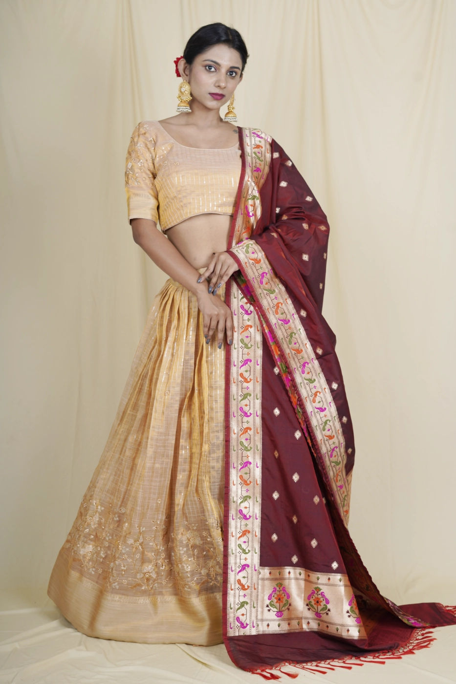 beige-color-chanderi-silk-lehenga-with-pearl-embroidered-border-and-all-over-embroidered-sequin-stripes-with-matching-blouse-and-maroon-patola-dupatta-m?uid=1675052579