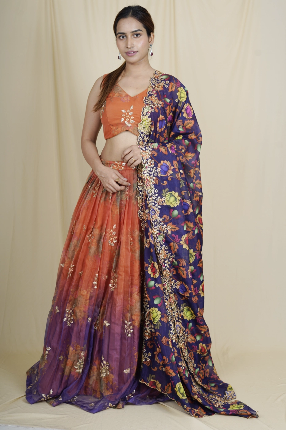 burnt-orange-organza-lehenga-with-purple-border-highlighted-with-embroidered-motifs-paired-with-matching-blouse-and-purple-floral-print-organza-dupatta-s?uid=1675052706