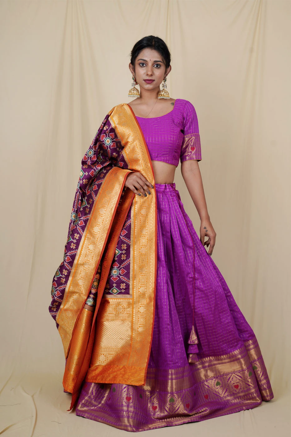 purple-silk-lehenga-with-all-over-checks-and-big-border-paired-with-matching-blouse-and-pure-patola-dupatta-m?uid=1676379886